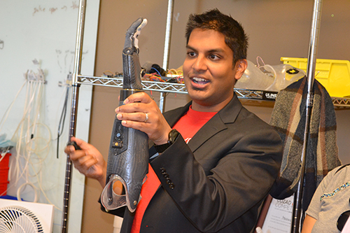 Aadeel Akhtar, CEO of Psyonic, shows the GBAM  campers one of their high-tech prosthetics.